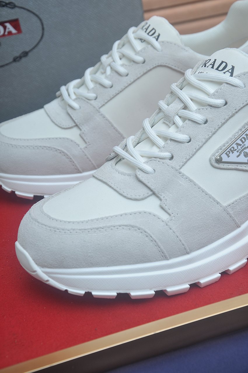 Prada Triangle Plaque Low-Top Sneakers — detail
